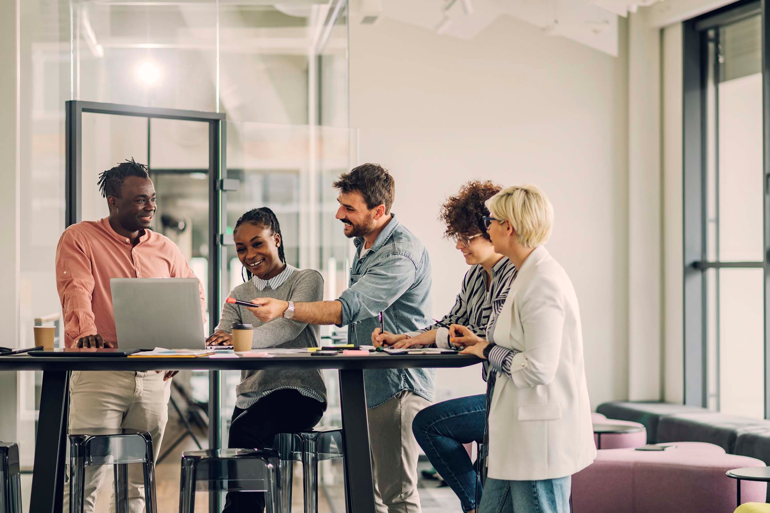 colleagues by a standing table