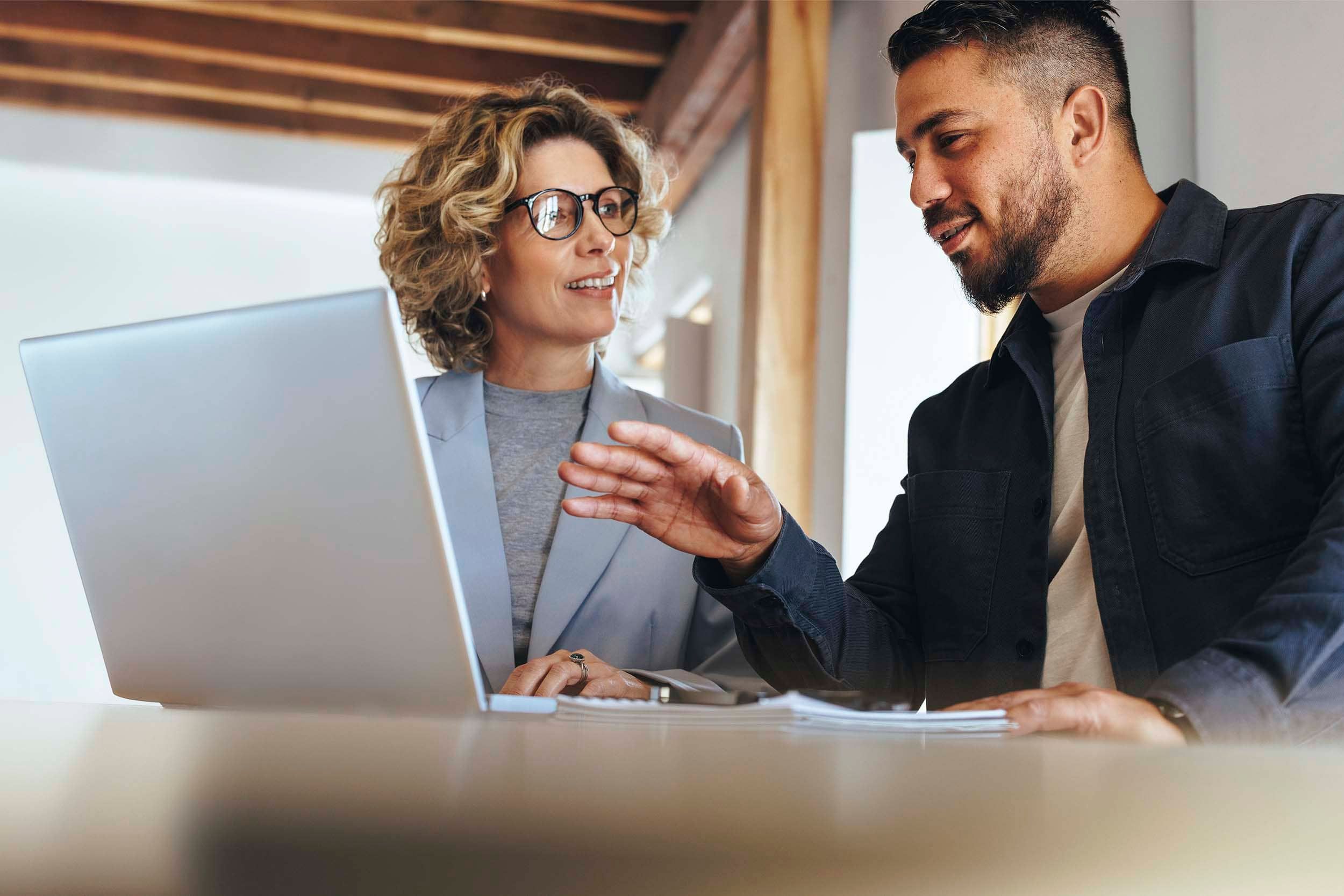 Colleagues looking at screen in office