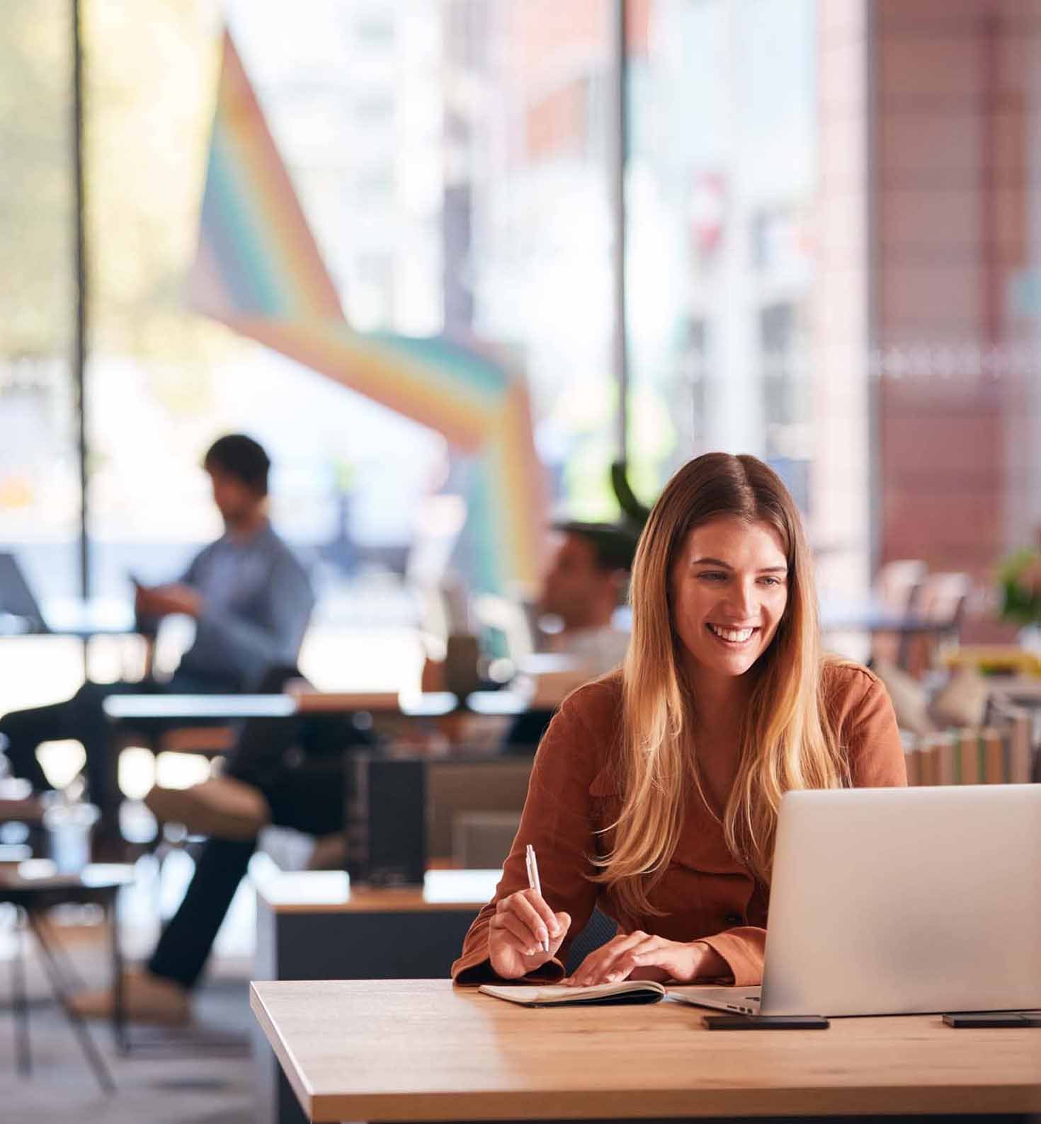 Woman working at office desk in a Hybrid Workplace - Key features (small image)