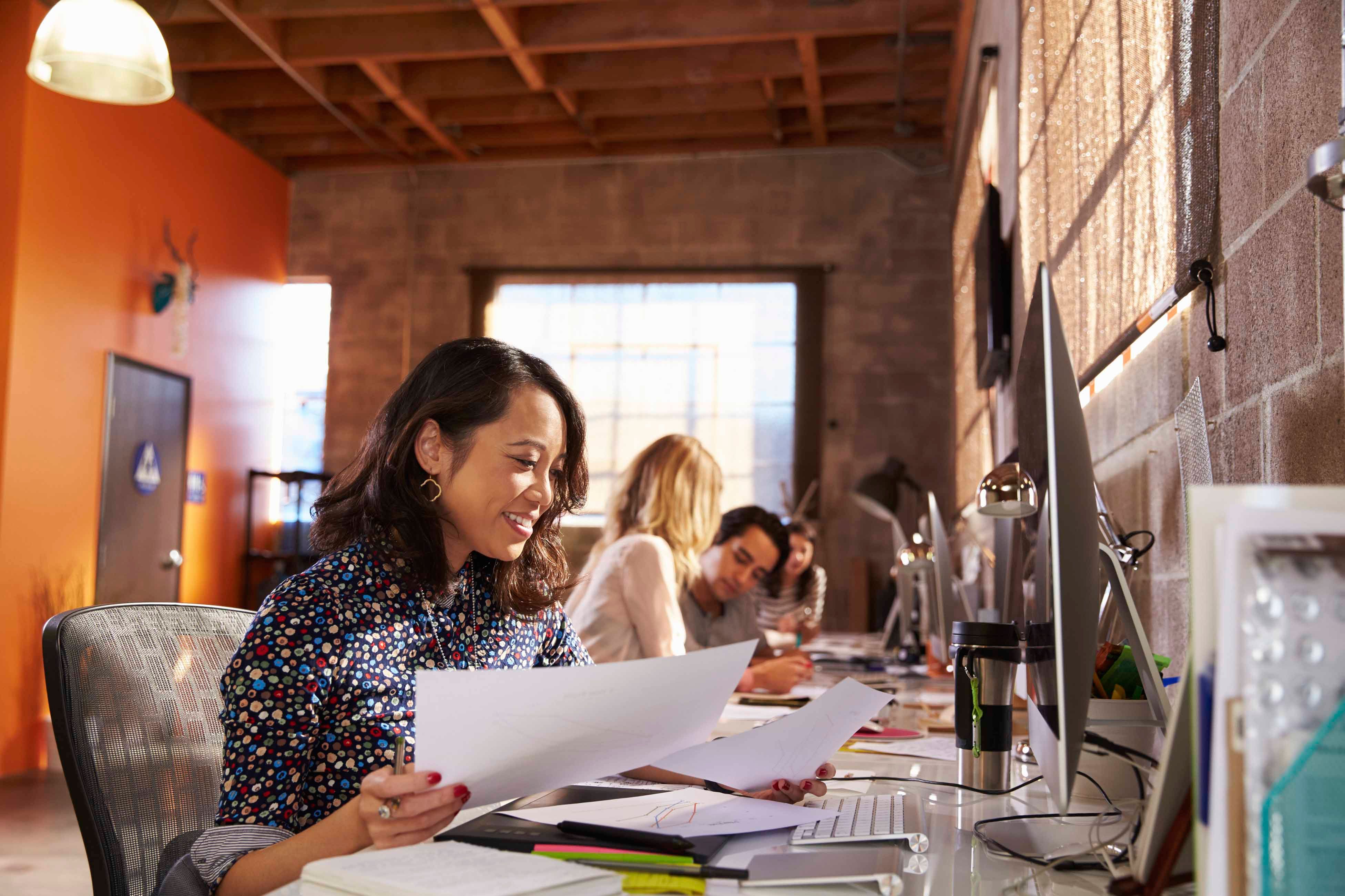 Woman working at a desk in office - general