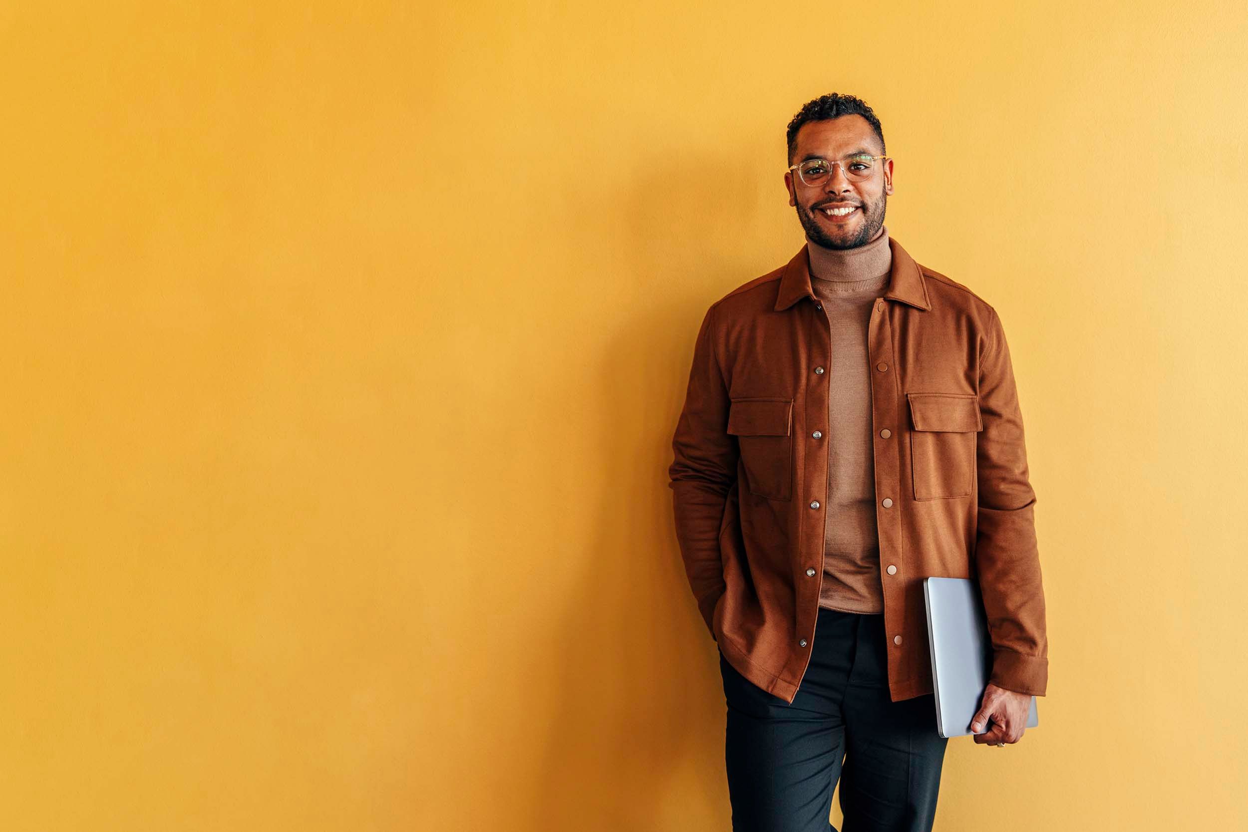 man infront of yellow wall