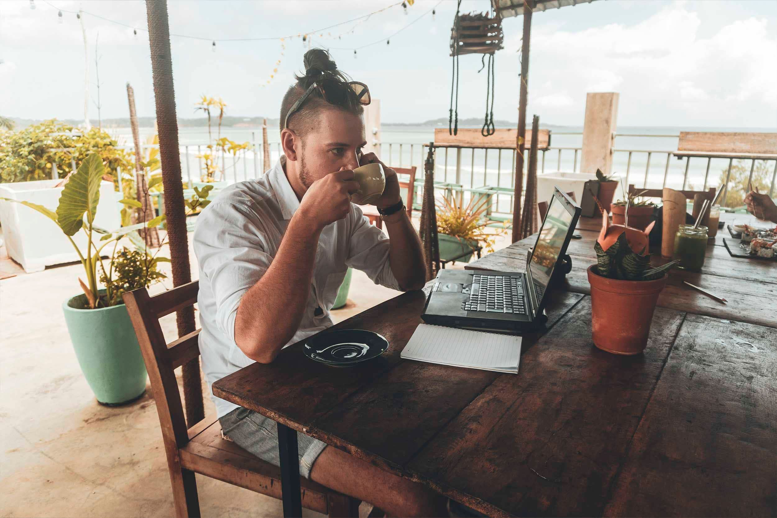 man working from beach