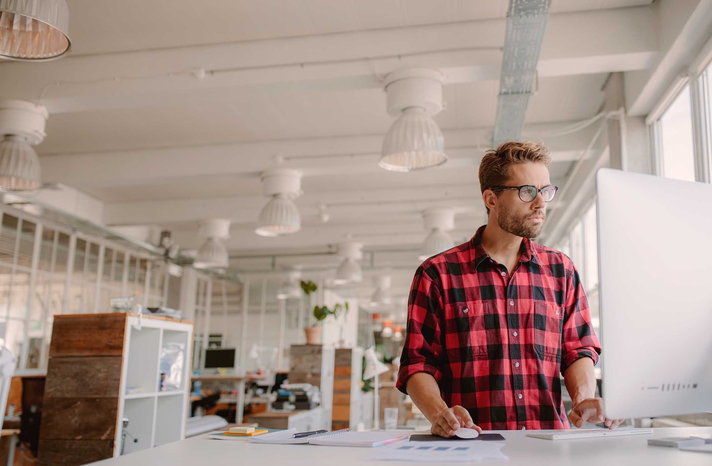 man working infront of screen