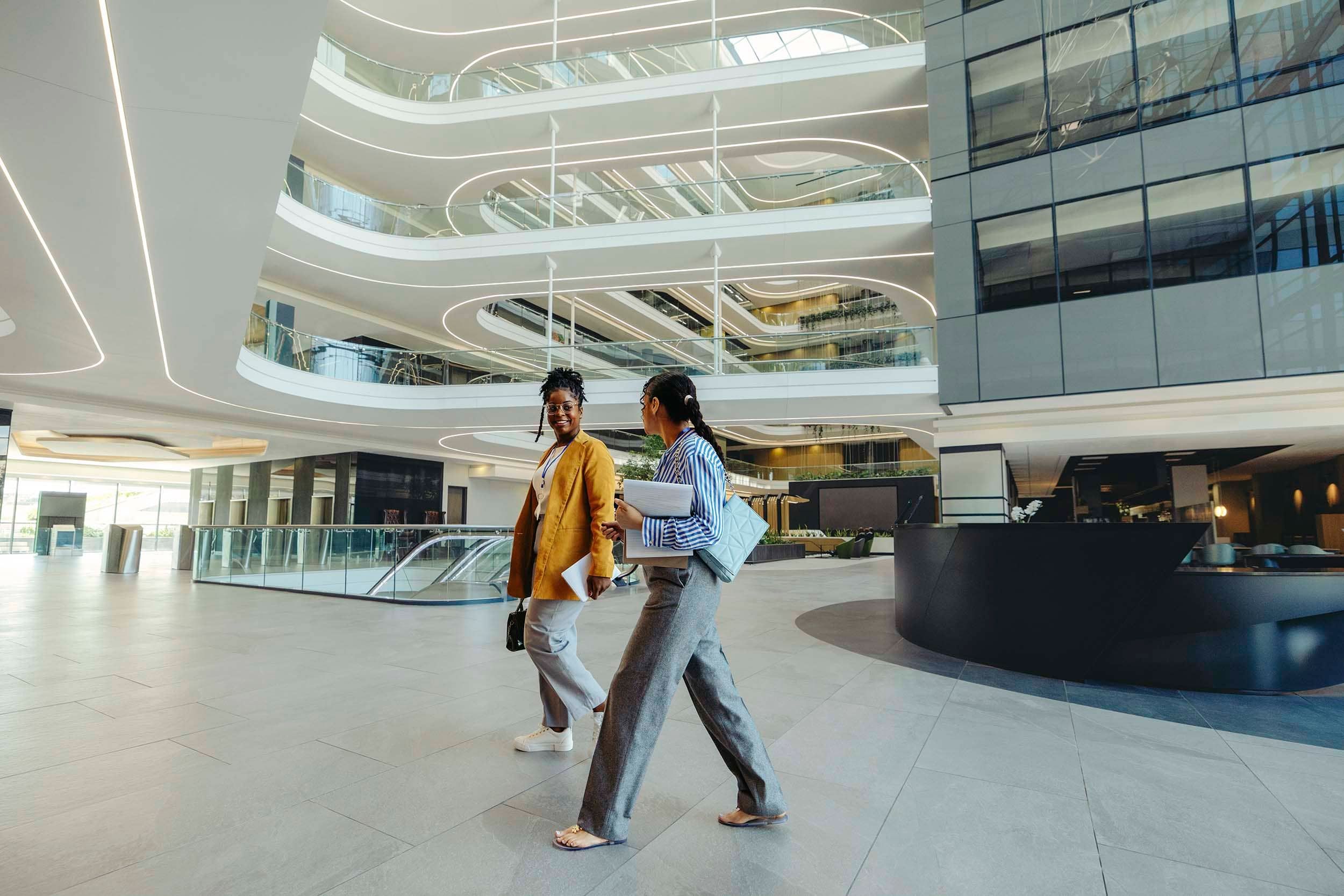 two women enter large building
