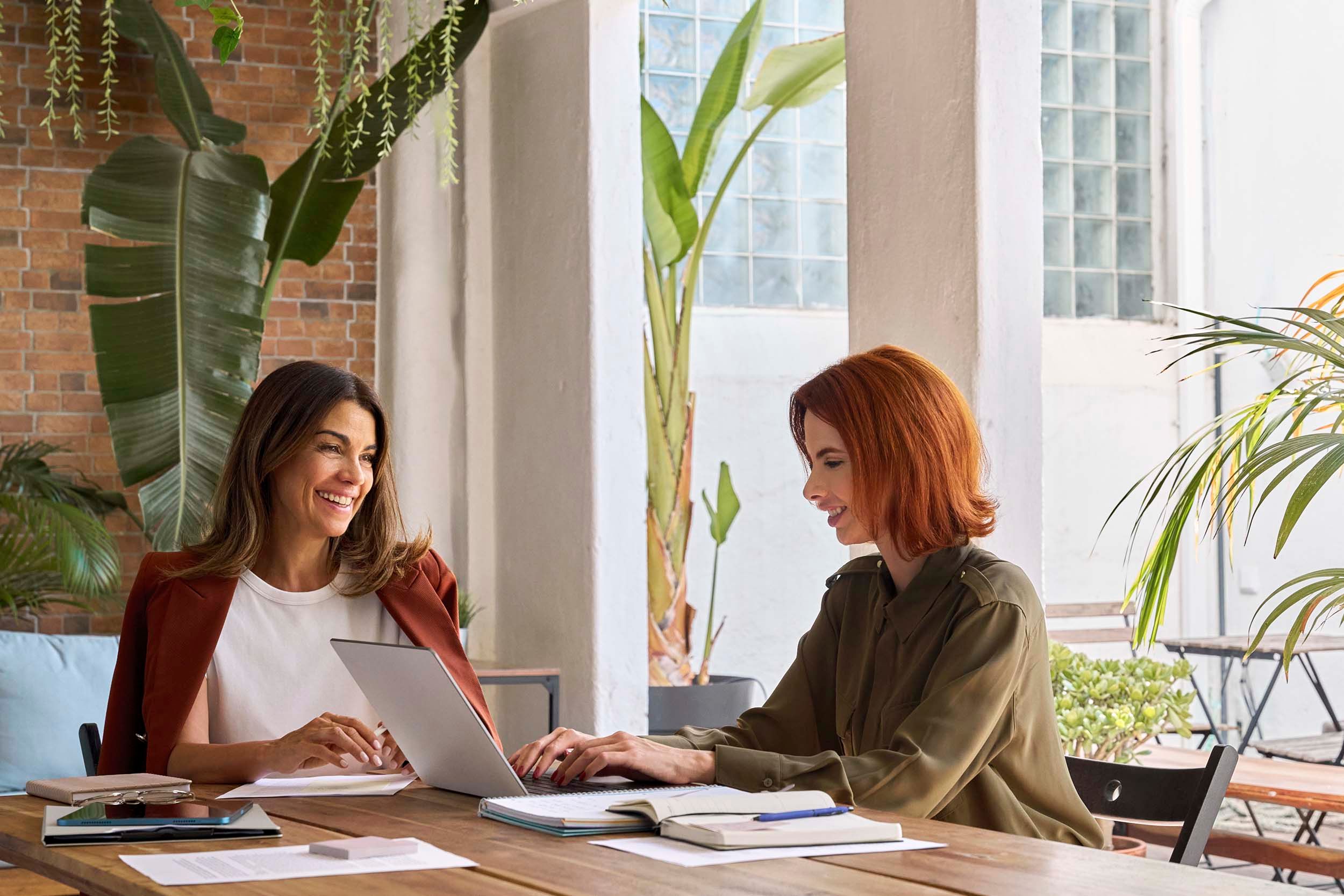 two women woking in green meeting room