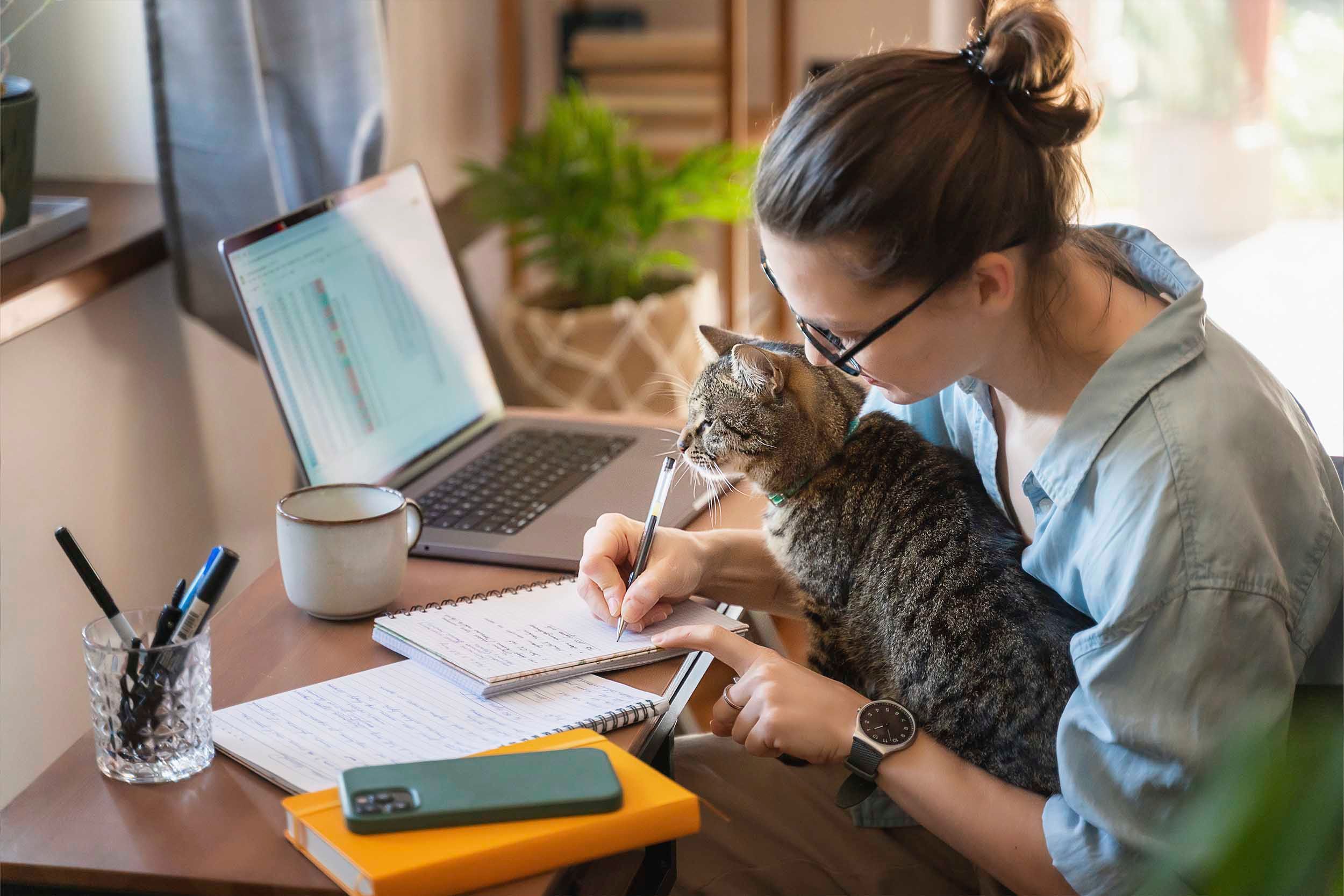 woman working from home with pet